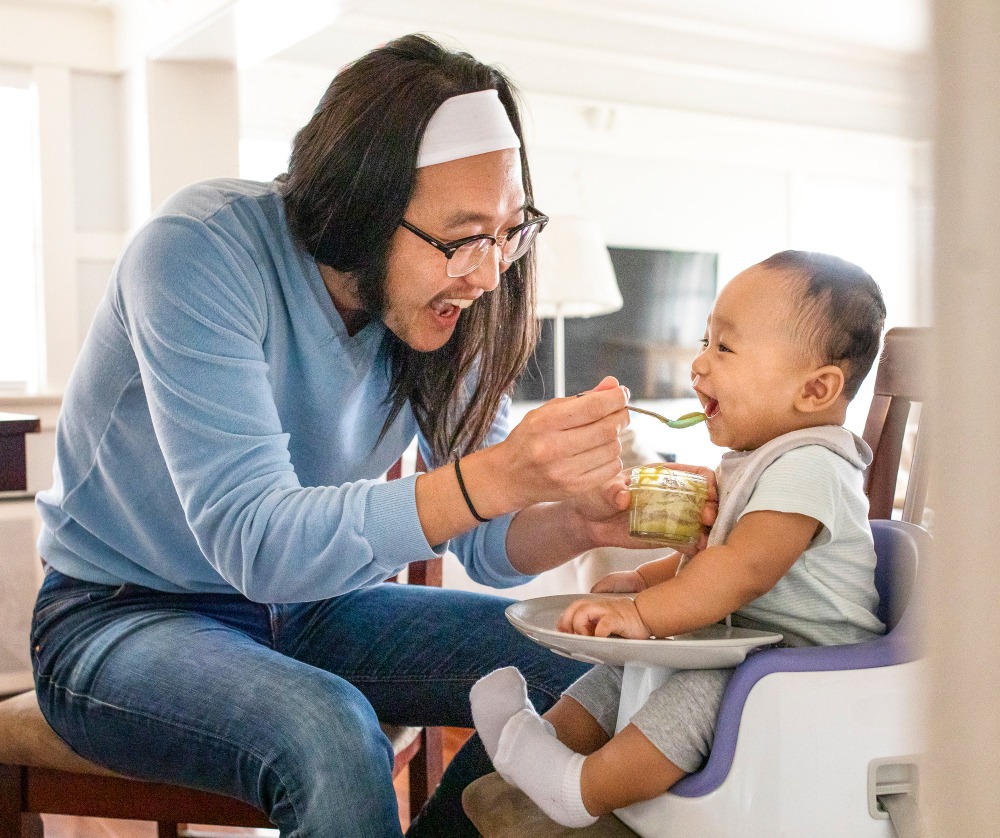 father feeding his baby son with puree for early weaning
Related tags: